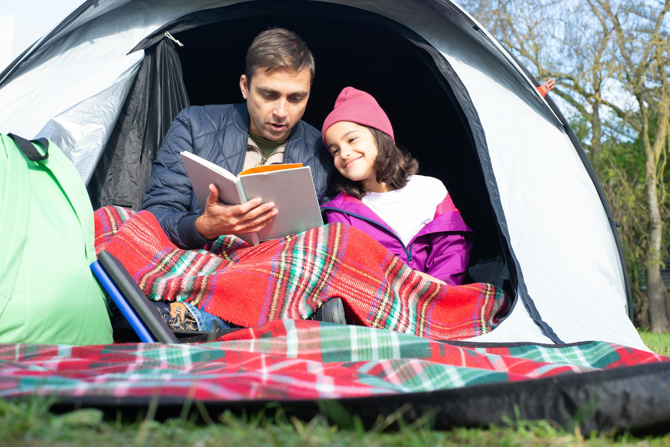 Man reading book to girl