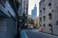 City with skyscrapers and buildings near road with trees