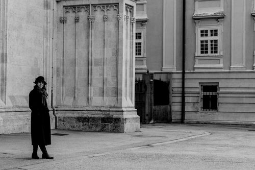 Free Woman in black coat stands by ornate architecture in Zagreb, Croatia. Stock Photo