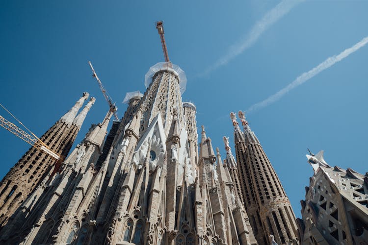 Exterior Of Aged Sagrada Familia Church Against Blue Sky