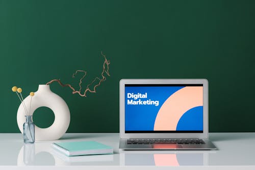 Free Silver Laptop on White Desk with Digital Marketing Label on Screen Stock Photo