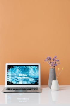 Modern workspace with laptop and decorative flowers showcasing digital marketing.