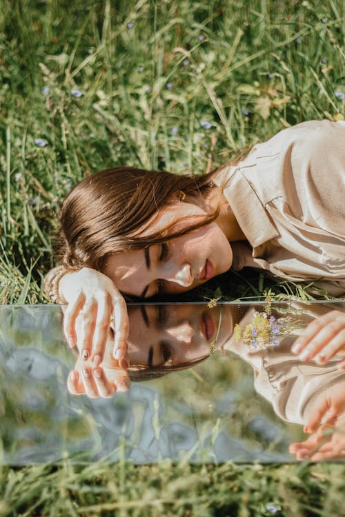 Free Photo of Woman Laying on the Grass Stock Photo
