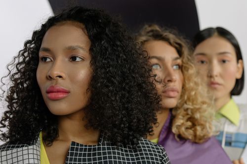 Free Portrait of diverse women showcasing unique hairstyles and natural beauty. Stock Photo