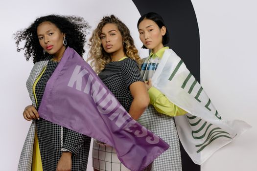 3 Women Holding Pink and White Textile
