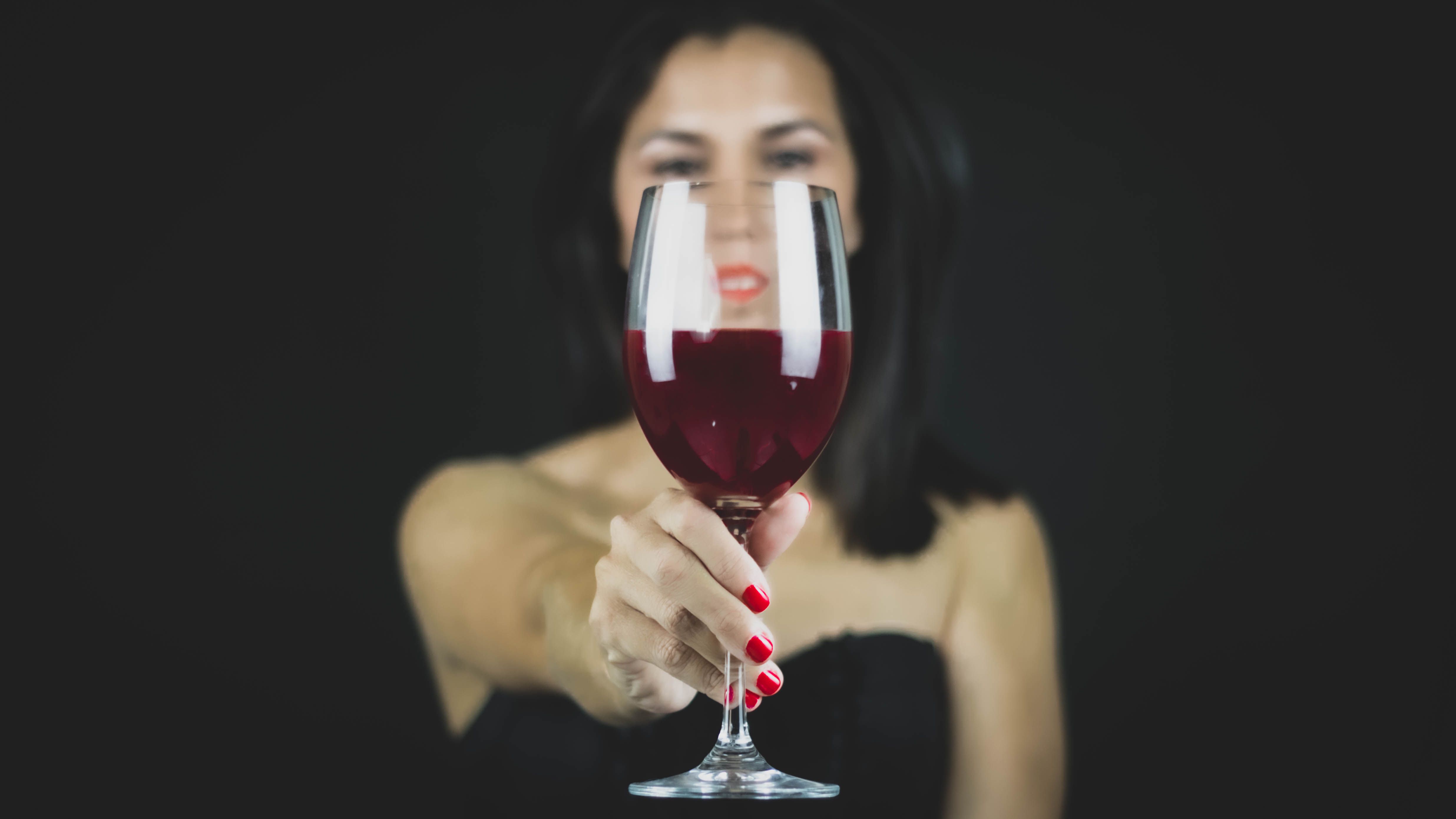 Woman Holding Glass of Wine · Free Stock Photo