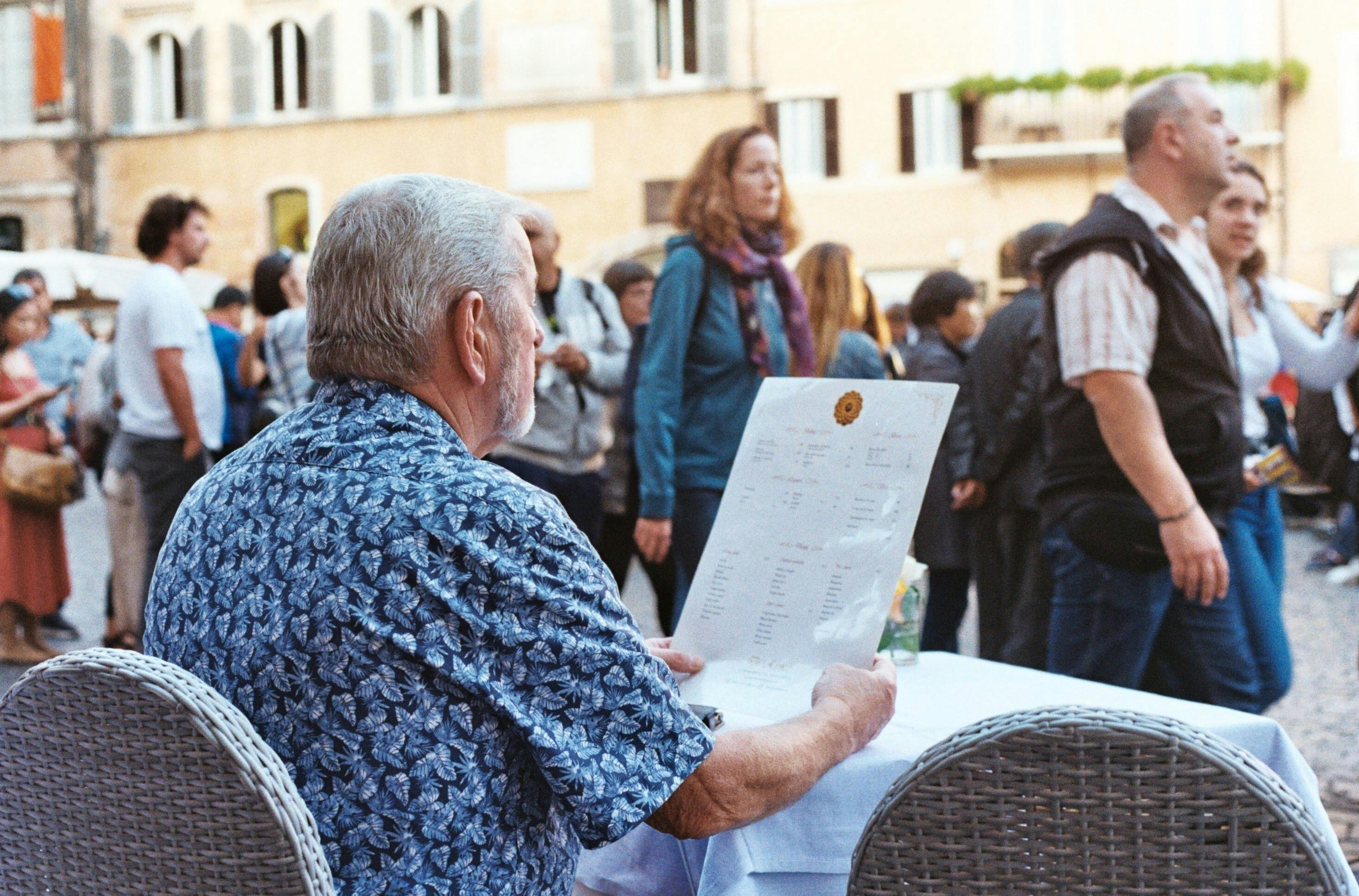a man reading a menu at restaurant