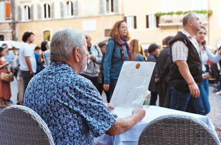 A Man Reading A Menu At Restaurant