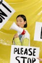 A Woman Holding a Megaphone in a Rally