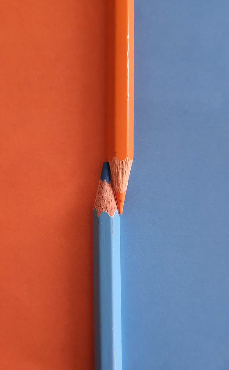 Orange And Blue Pencils On Orange And Blue Surface