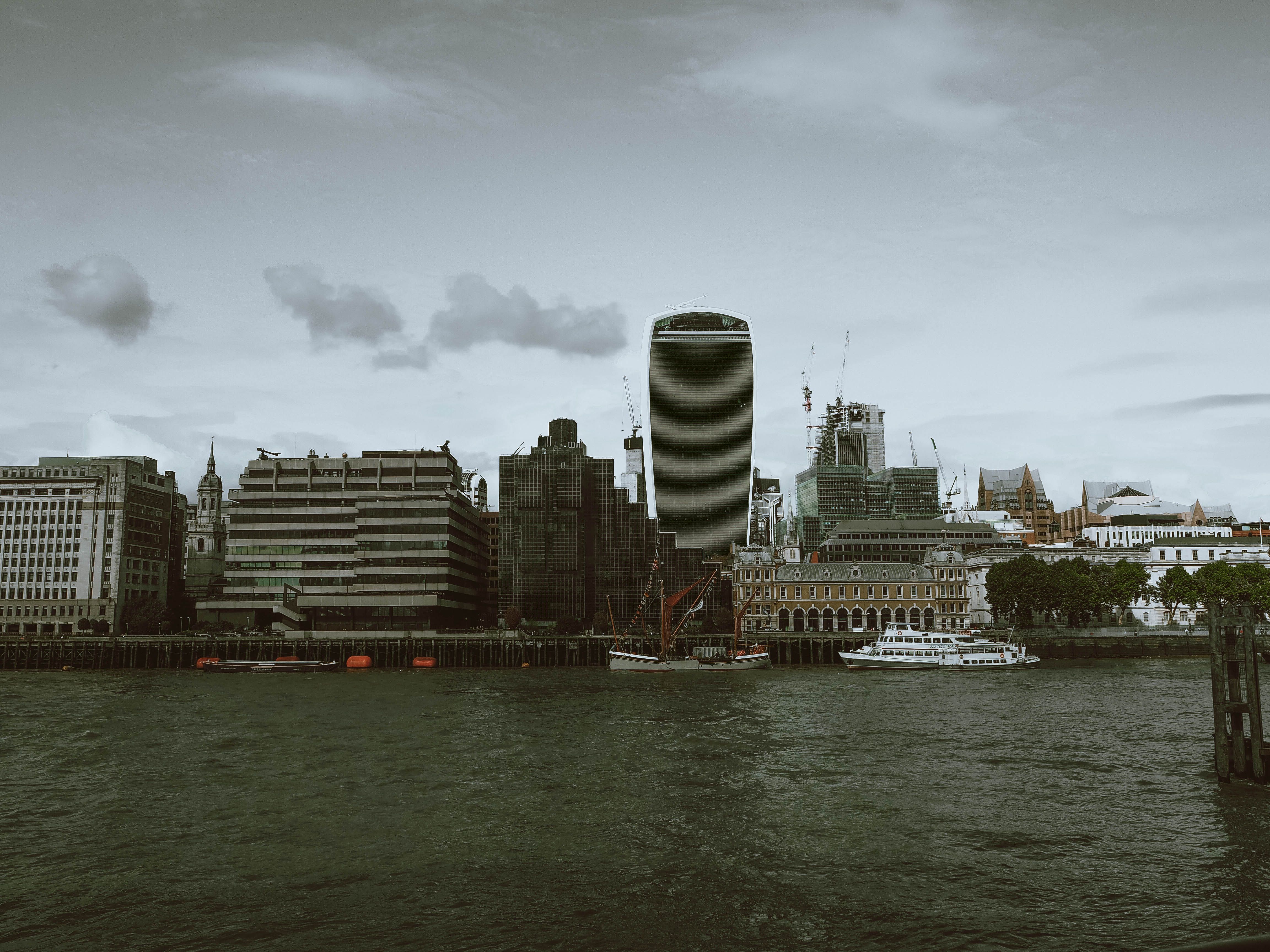 London skyline featuring the iconic Walkie Talkie building along the Thames River waterfront.