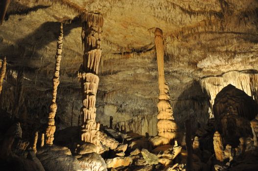 Explore stunning stalactites and stalagmites in a Spanish cave, showcasing natural wonders.