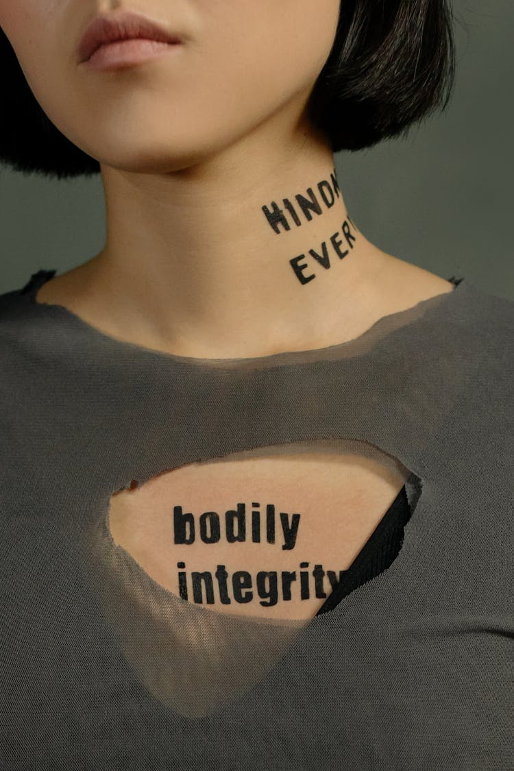 Person Standing With Slogan Quotes On Her 
Neck And Chest