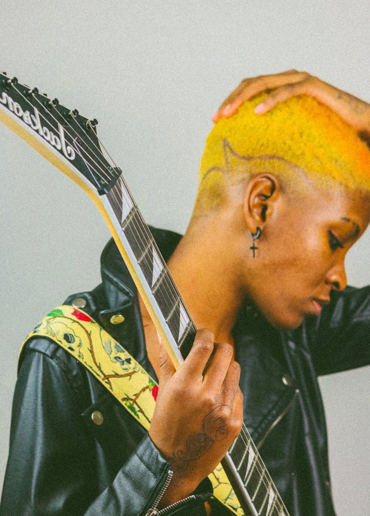 Serious Young Black Woman With Electric Guitar Against White Background