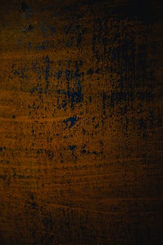 A richly textured surface with rustic and vintage dark tones, ideal for backgrounds.
