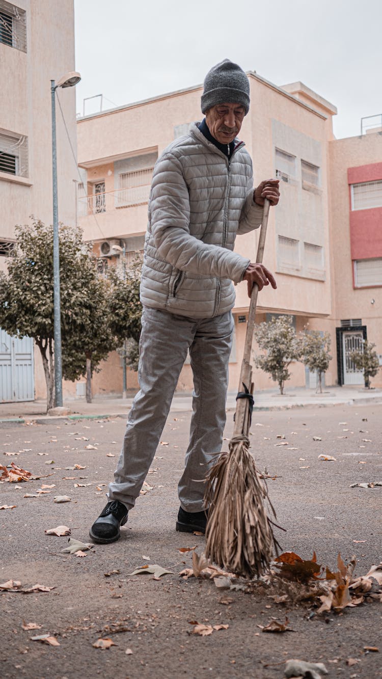 Man Sweeping The Street