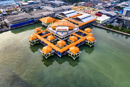 Stunning aerial view of the unique floating restaurant in Jakarta, surrounded by urban architecture.