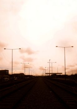 Railroad tracks and street lights in a scenic Nigerian sunset.
