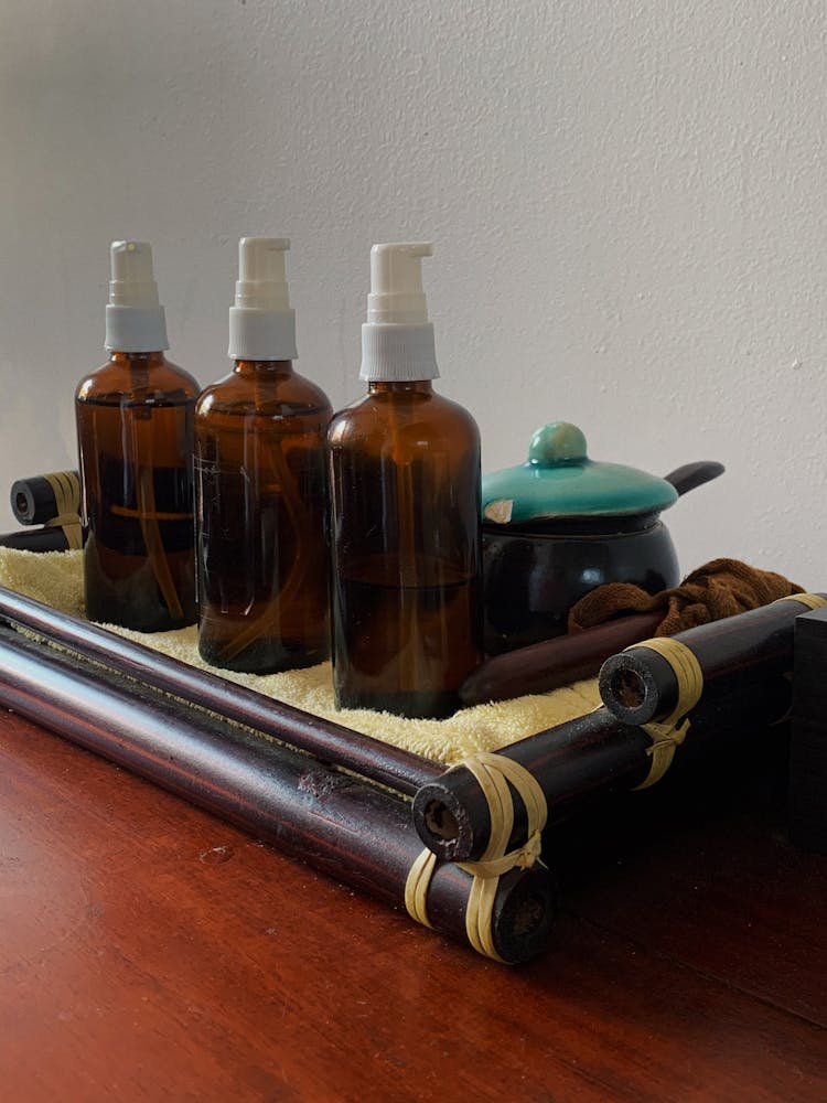 Spray Bottles On A Bamboo Tray