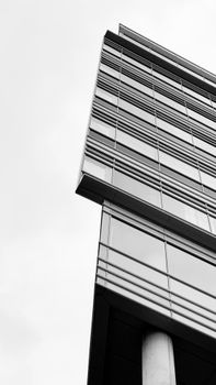 Black and white photo of modern architecture in Amsterdam with a low angle view.