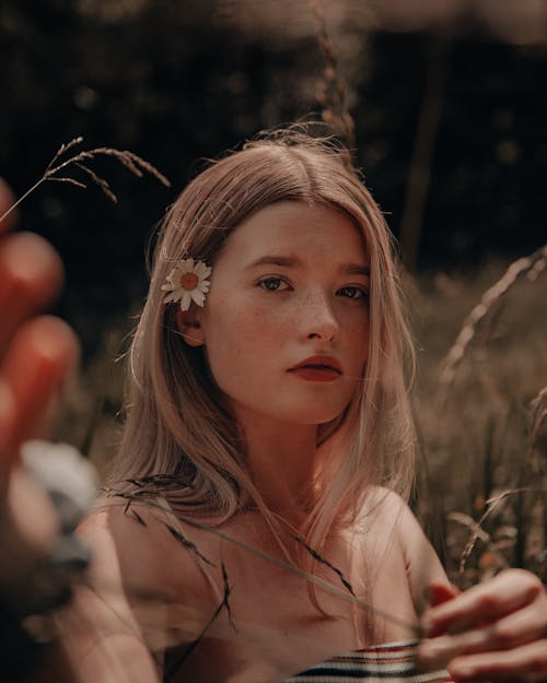 A Woman in Tube Top with Daisy Flowers Behind Ear