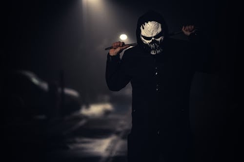 Free Person in Black Jacket Wearing White Scary Mask Stock Photo