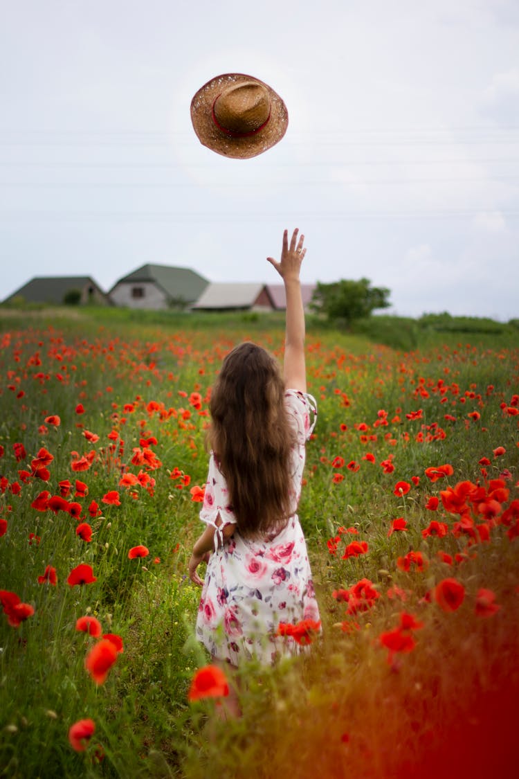 A Woman Throwing Her Hat In The Air 