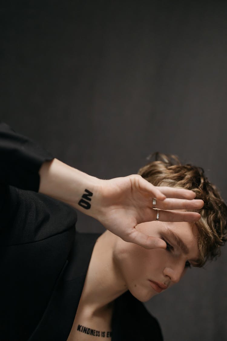 Young Man In Black Blazer With Quotes Message On Body