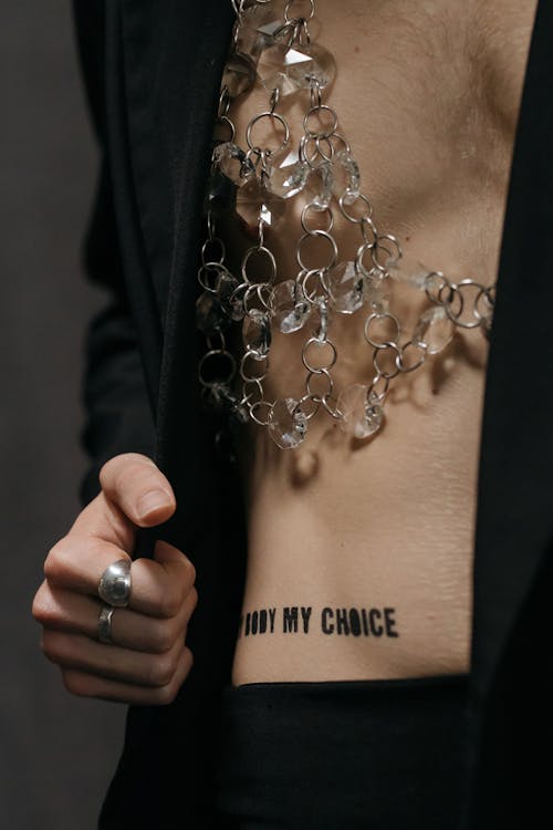 Person in Black Blazer with Quote Words on Body