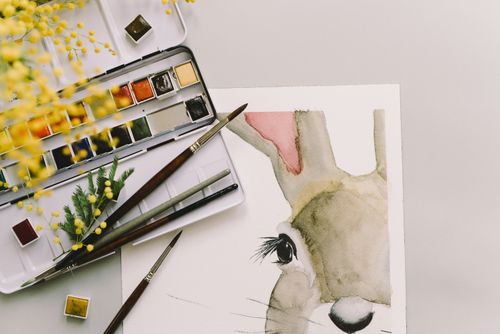 Free Artistic Easter bunny watercolor with brush and mimosa flowers on a spring day. Stock Photo