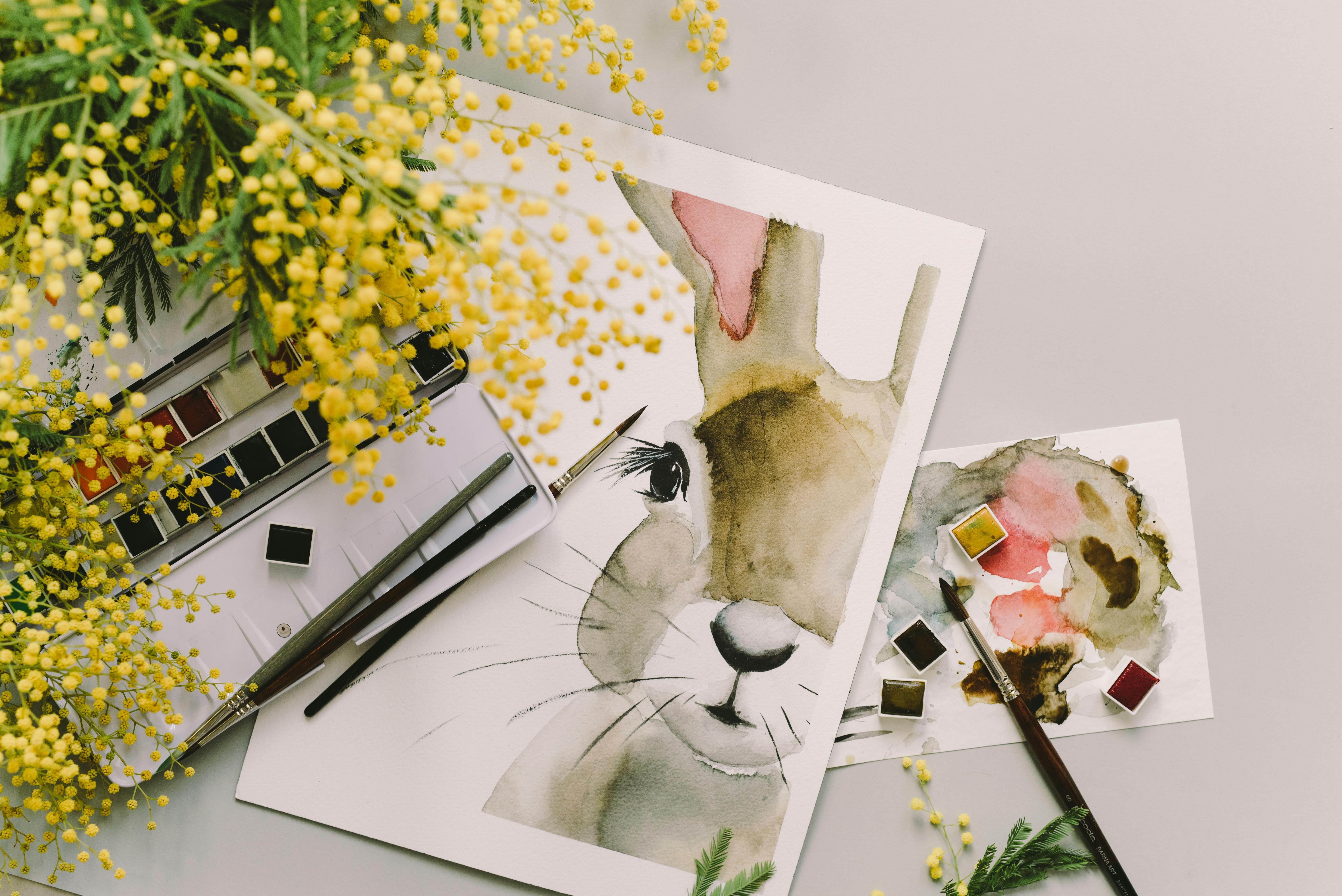 painting of a bunny beside yellow flowers