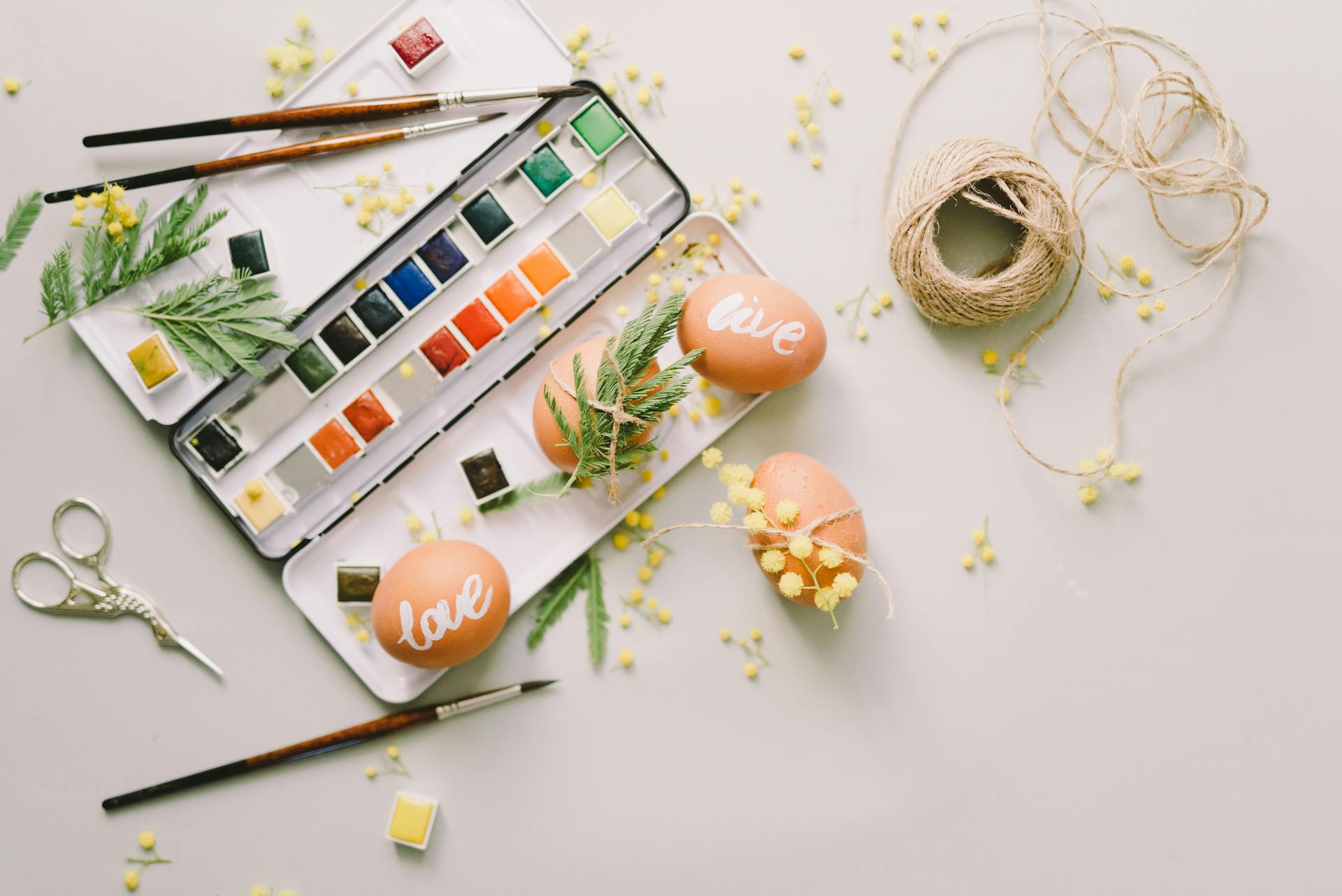 Watercolor, Brown Eggs and Twine on the Table for Decorating Easter Eggs