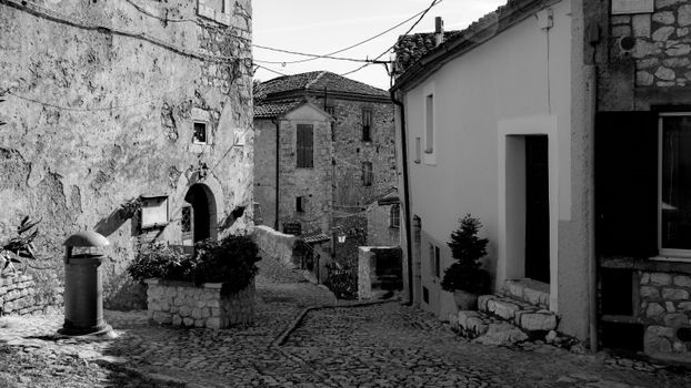 Black and White Photo of an Old Town Street with Cobblestone