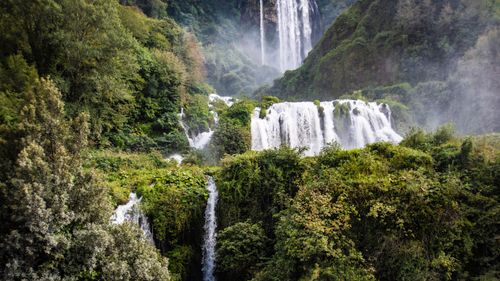 Free Explore the beauty of cascading waterfalls amidst lush forest greenery, captured in vivid detail. Stock Photo
