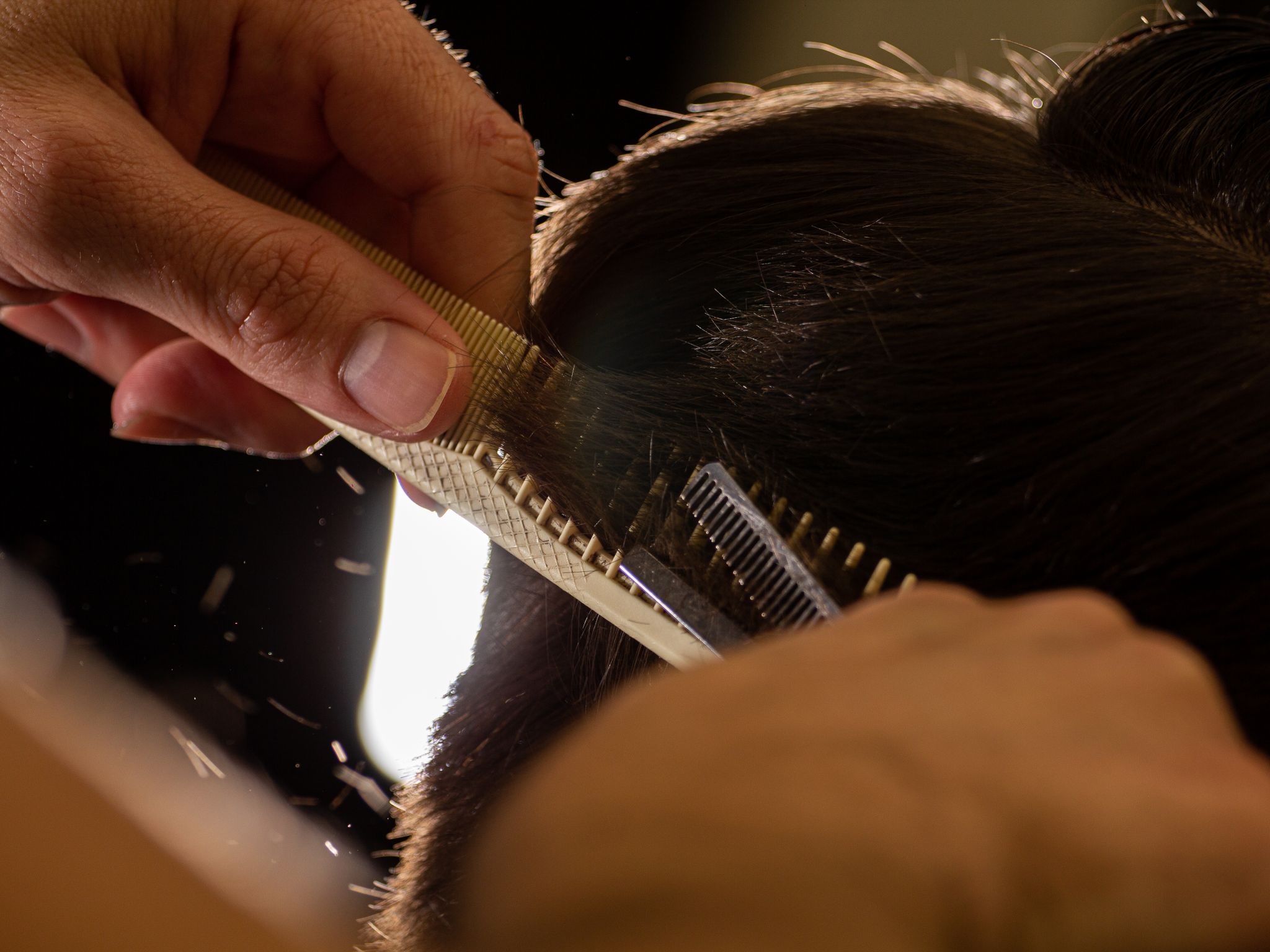 Stylist cutting hair in a salon