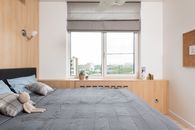Home interior with bed with rabbit toy near window