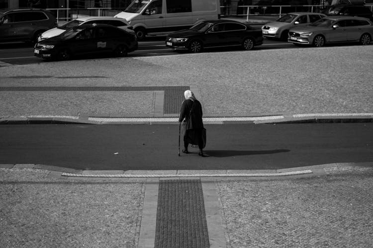 An Elderly Woman Crossing The Street