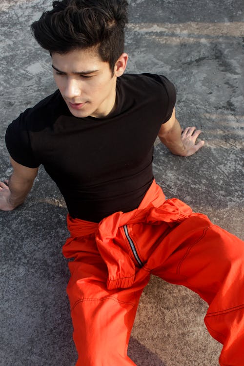 A Man Wearing a Black Shirt and Red Pants