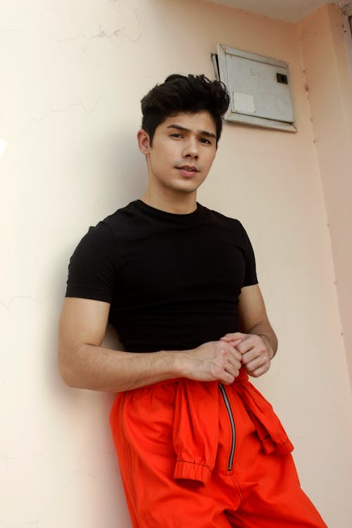 A Man Wearing a Black Shirt and Red Pants