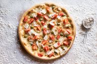 Tasty pizza with Parmesan cheese and fresh tomato slices