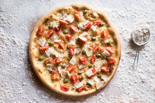 Tasty pizza with Parmesan cheese and fresh tomato slices