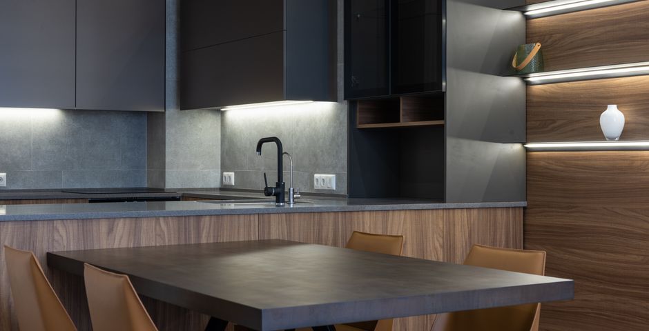 A kitchen sink and cabinet run — the pipe entry under the sink is one of the most common indoor entry points