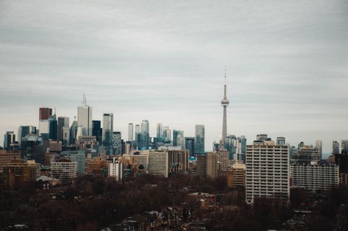 Free Stunning view of Toronto's skyline with the iconic CN Tower under a cloudy sky. Stock Photo