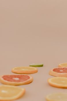 Artistic arrangement of citrus slices including oranges and grapefruits with copy space.