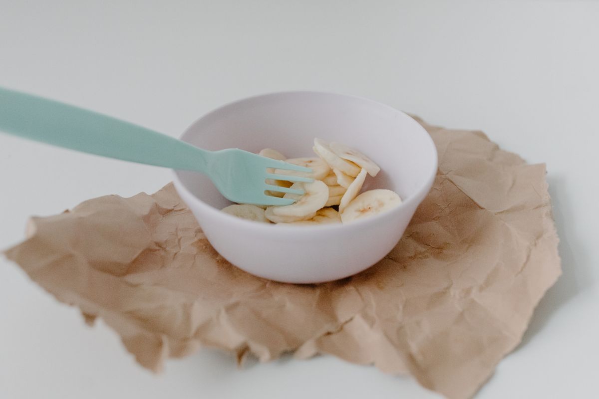 Sliced ripe banana in a white bowl as a possible egg substitute for pancakes