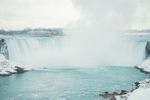 A stunning wintry scene of Niagara Falls showcasing its majestic beauty and icy surroundings.