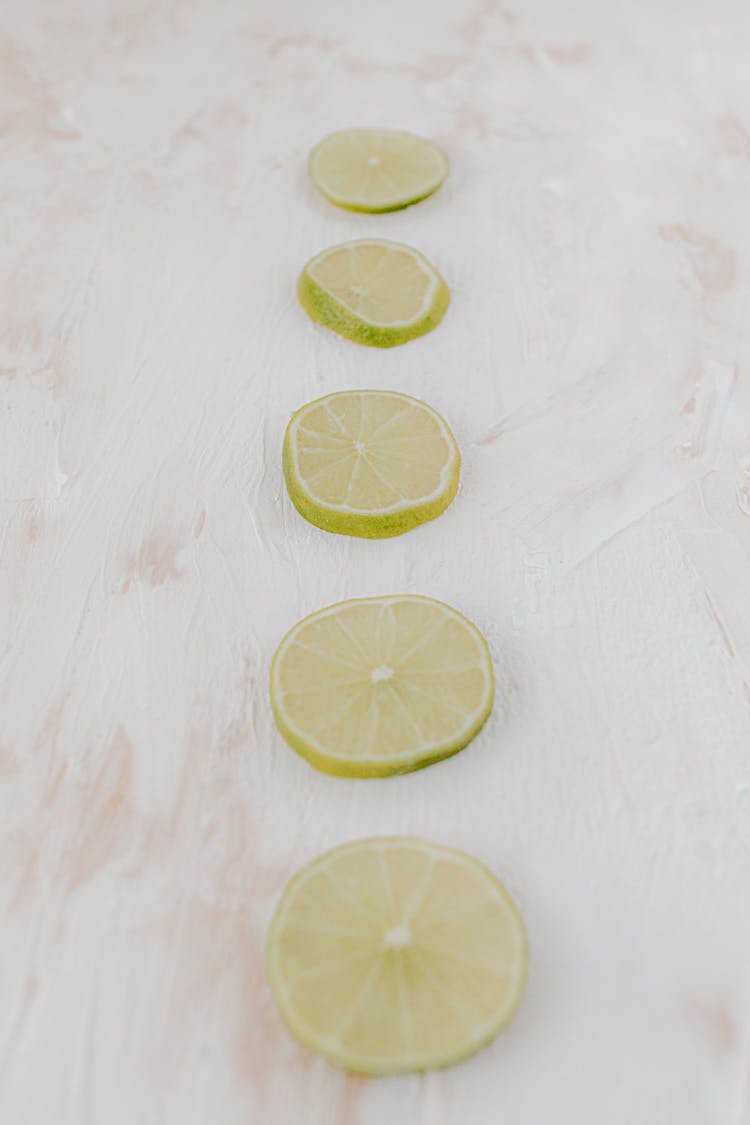 Sliced Lemon On White Surface