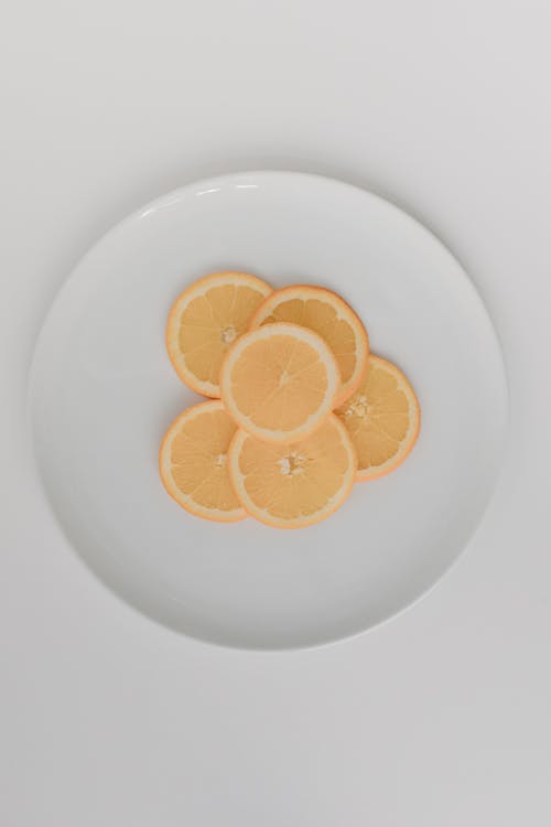 Sliced Orange on White Ceramic Plate