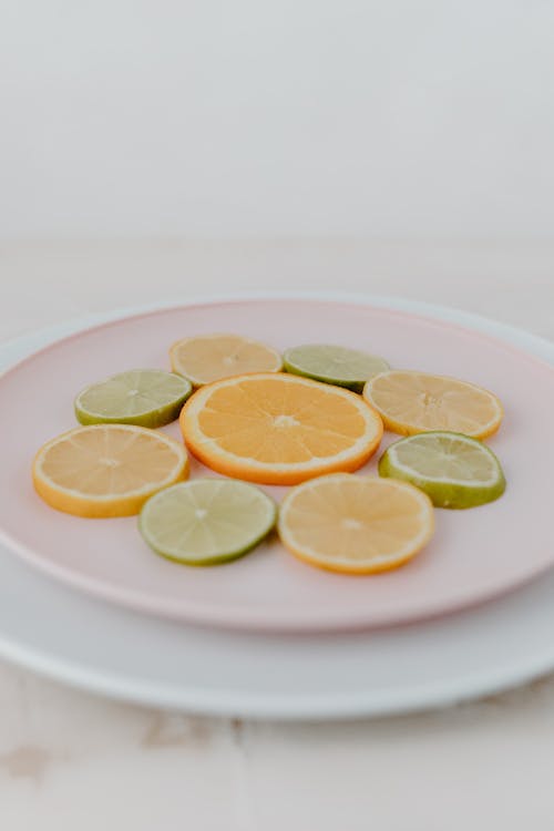 Fruits Slices on Pink Ceramic Plate