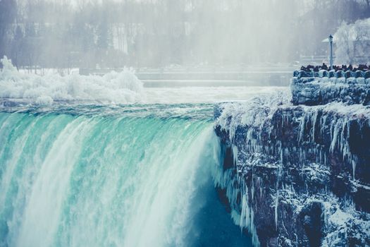 Breathtaking view of a frozen waterfall during winter with icy formations.